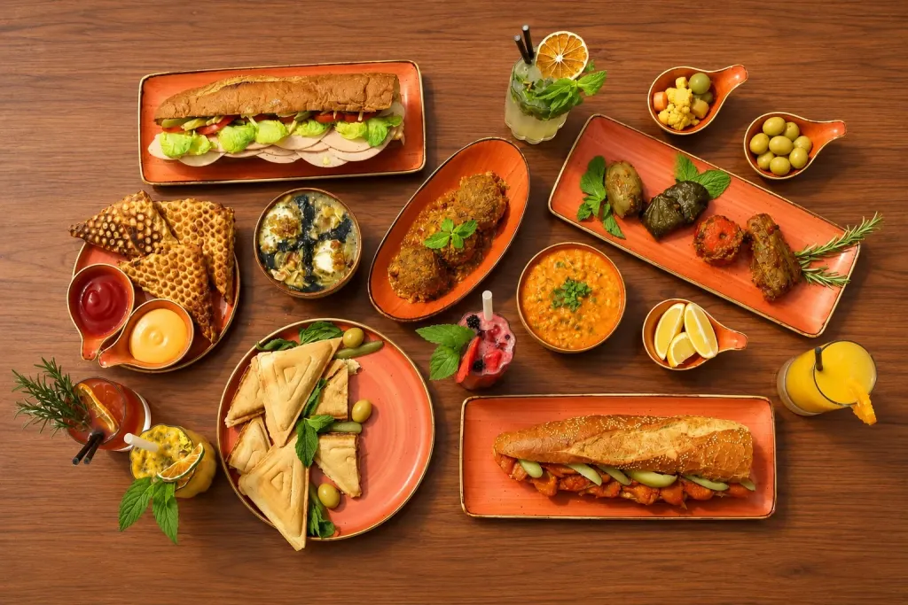 Sweet Crown's savoury menu laid out on a wooden table: rolls, toasties, soup, mocktails and dips
